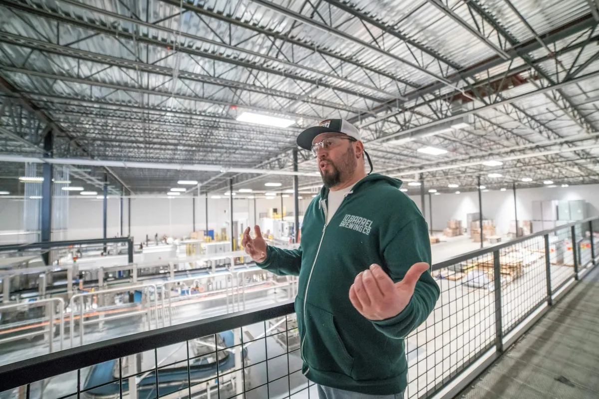 A warehouse manager on a mezzanine above the floor