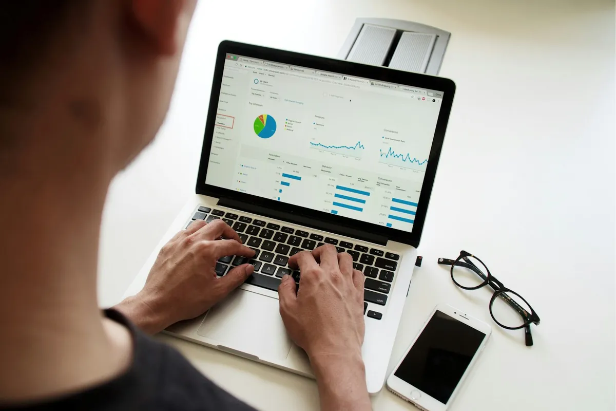 A person reviewing charts on a laptop