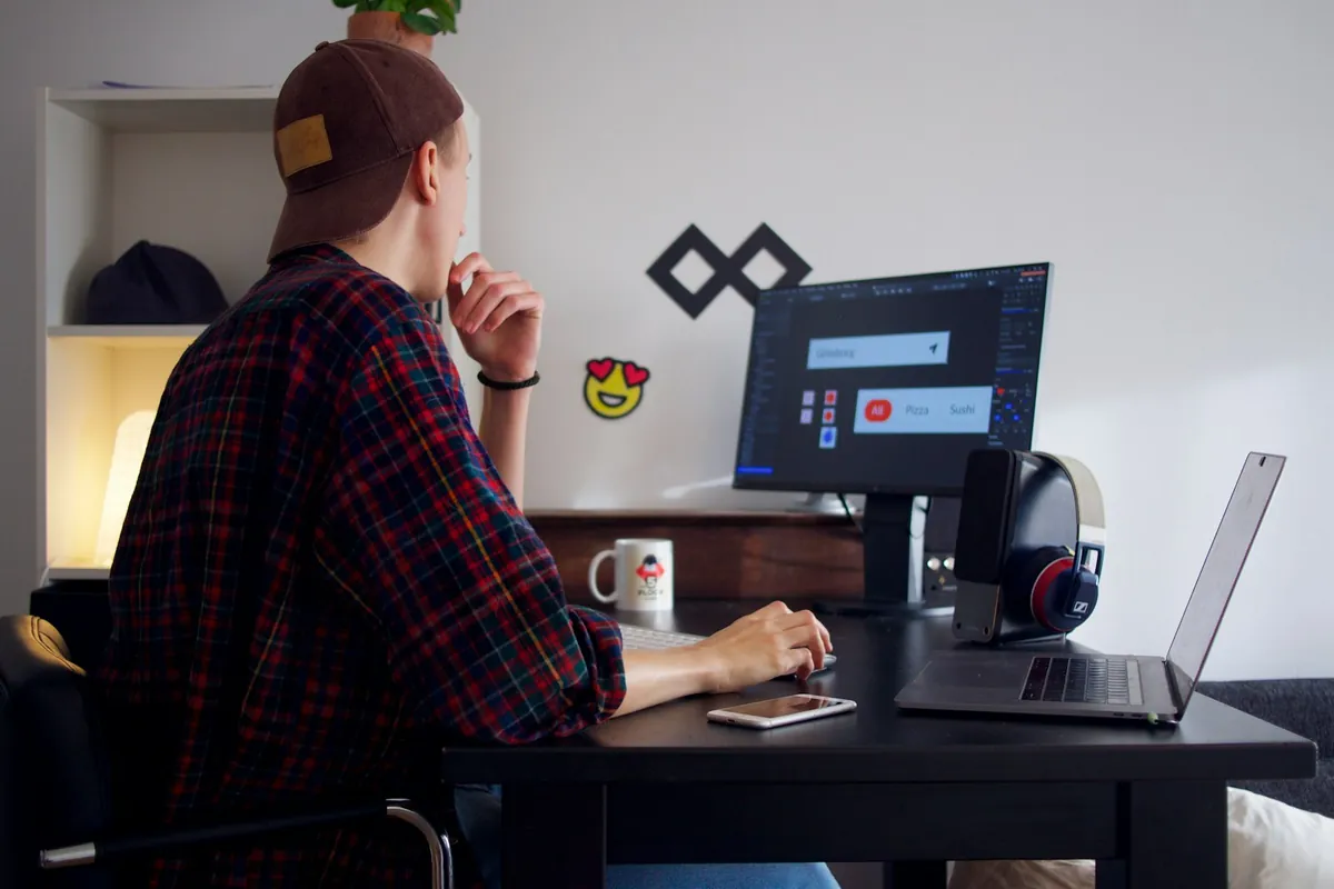 A person working at a laptop at home