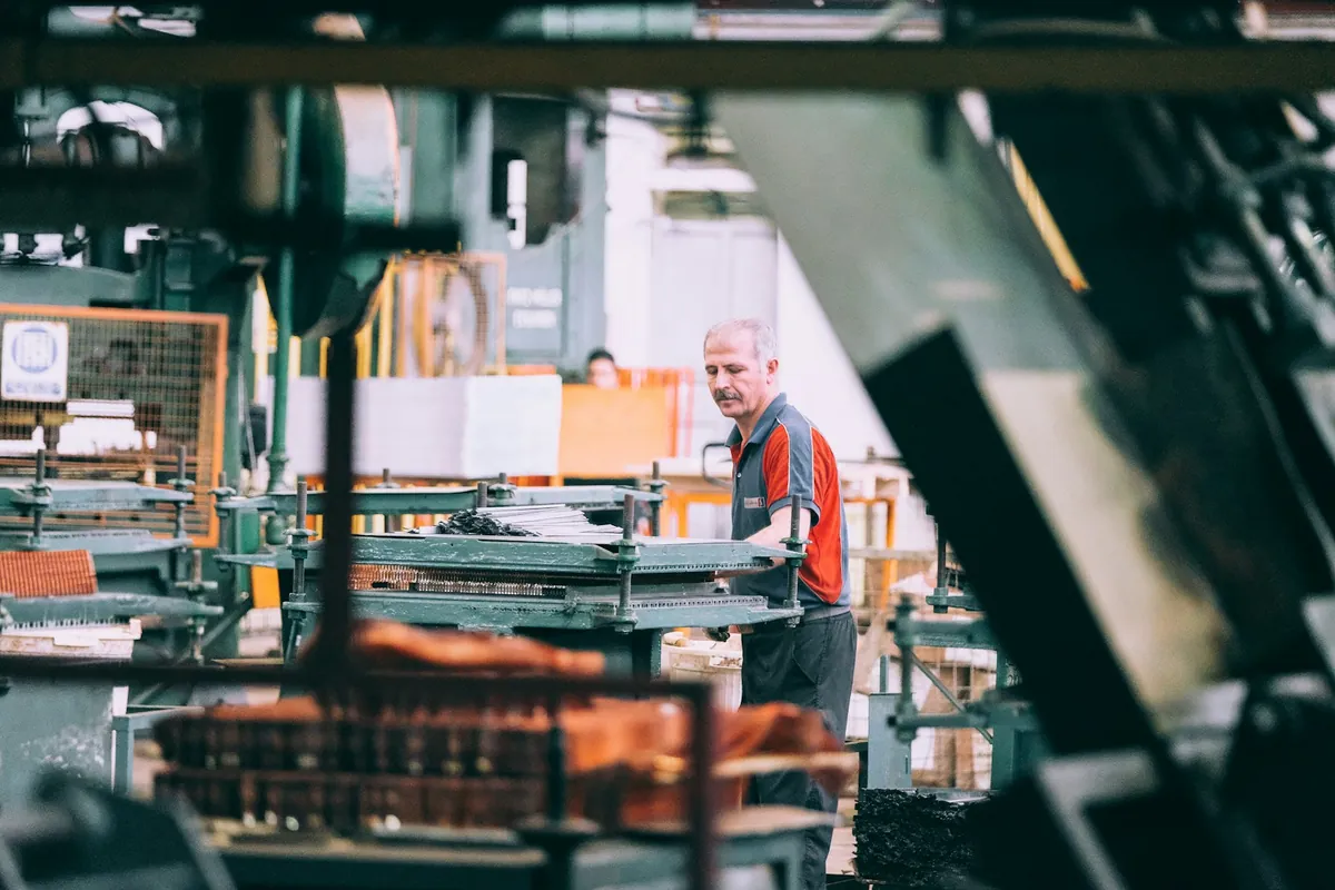 A worker in a busy workshop