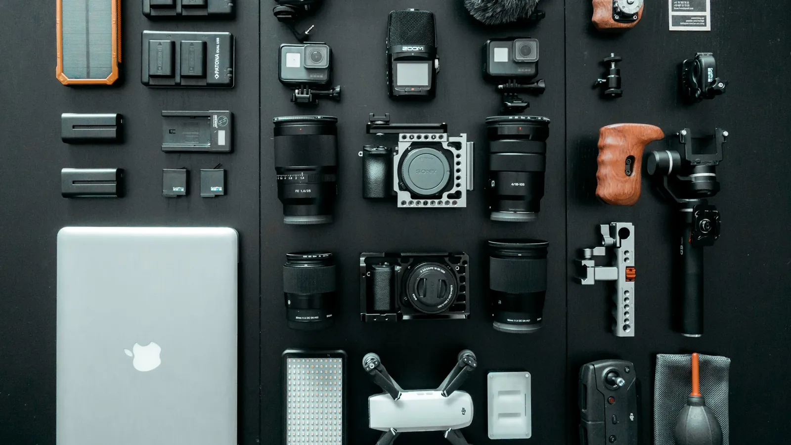 Filmmaking kit laid out neatly on a dark table