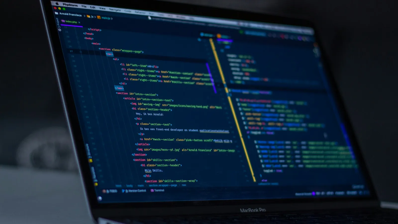 Code on a laptop screen in a dark room