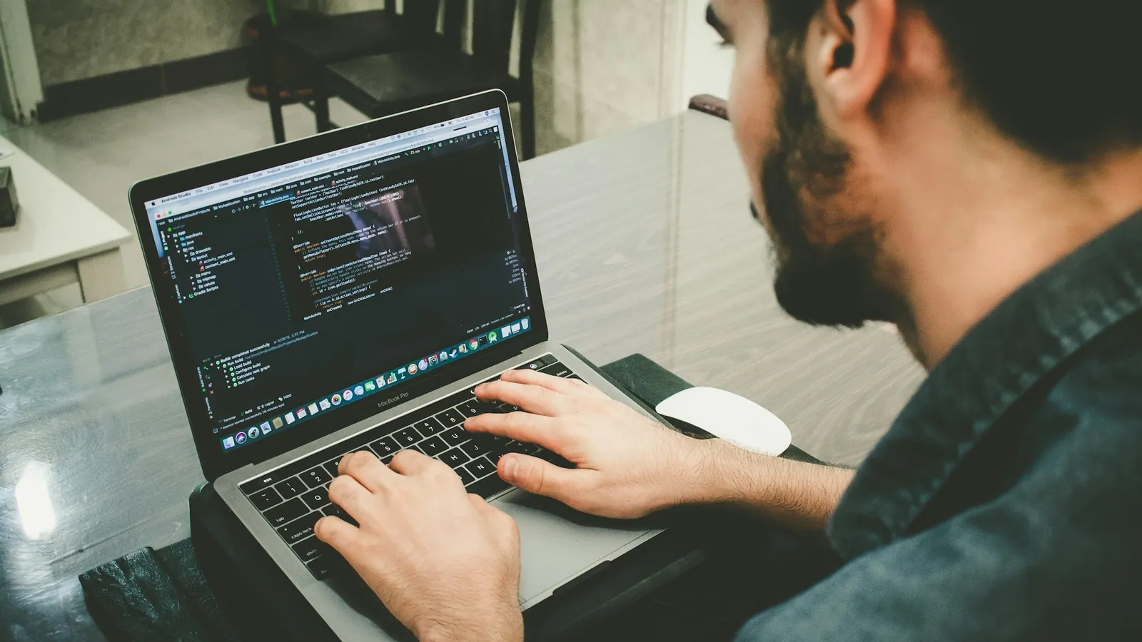 A developer typing code on a laptop