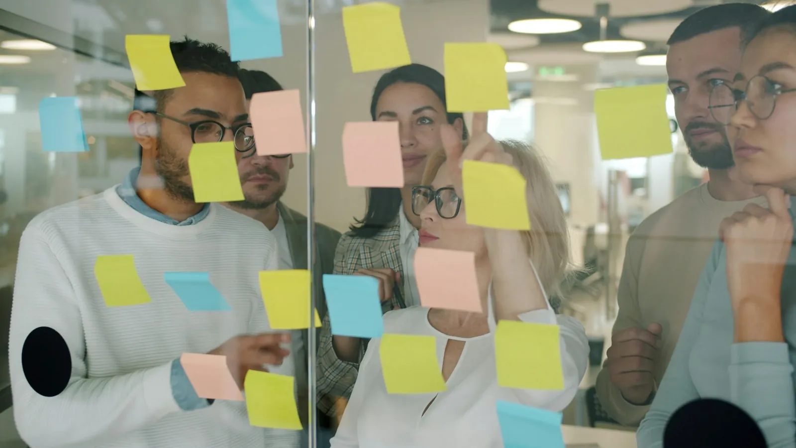 Colleagues planning together with sticky notes