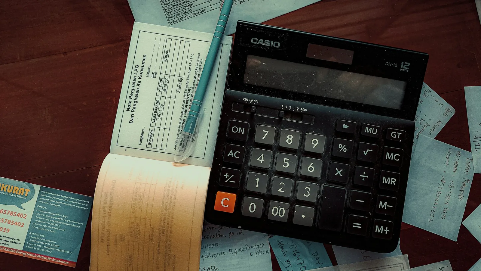 A calculator on top of invoices and receipts