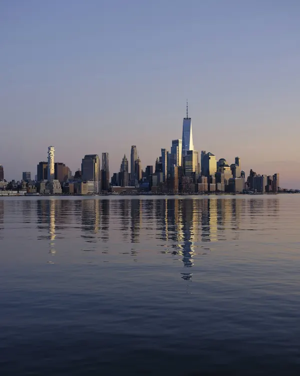 A city skyline across the water at dusk