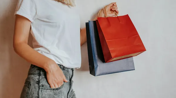 A shopper paying at a boutique counter