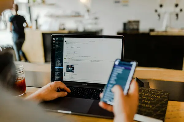 Laptop and phone open to an email inbox